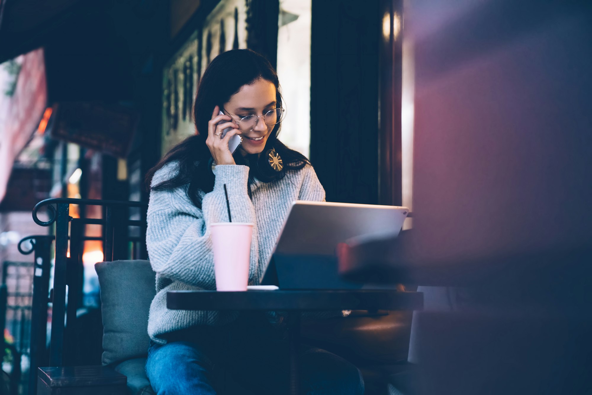 Female chatting on smartphone at the best cafes in mississauga